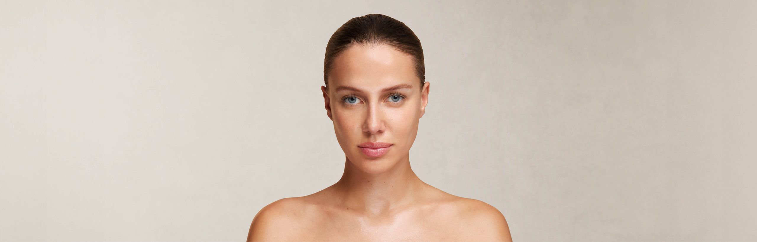 Frau mit zur&uuml;ckgebundenem Haar und nackten Schultern im Portr&auml;t